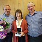 Keith and Gordon presenting Karen with her gifts for 20 years service
